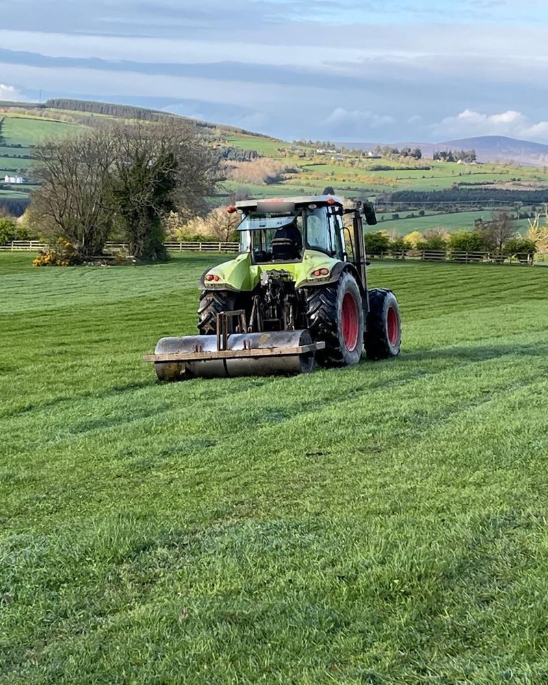 A tractor rolling one of the paddocks
