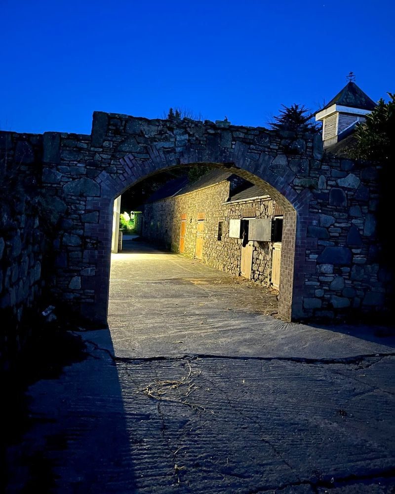 The stone archway into the stable yard at dusk